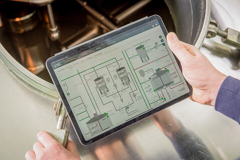 Tablet with minglecontrol is held over a boiler